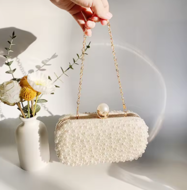 Elegant women’s oval crystal and pearl beaded clutch handbag with crossbody chain, perfect for weddings and evening events