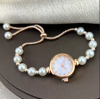 Elegant women's quartz watch with small Roman numeral dial and pearl bracelet strap, stylish wristwatch for ladies